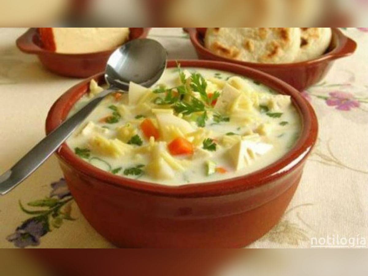 Plato de barro con pisca andina: sopa de papas con huevo escalfado, queso ahumado y cilantro