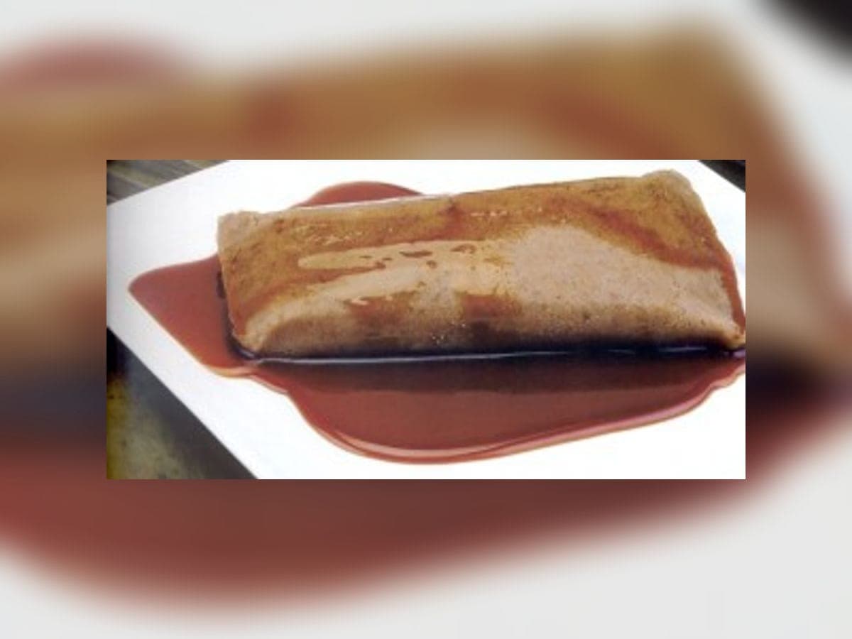 Cafunga de cambur bañada en melado, servida en un plato blanco